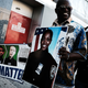 Calvin Hunt stands with his son Cameron while holding a Blue Lives Matter banner and a picture of New York City Police Officer Miosotis Familia outside a Bronx, N.Y., church during the funeral July 11, 2017, for Officer Familia, who was shot and killed last week in what police have called “an unprovoked attack” as she sat in an NYPD mobile command vehicle. (Spencer Platt/Getty Images)